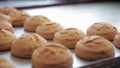 Ruddy buns lying on table in bakeryhouse.