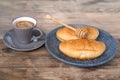 Ruddy fresh croissants on a dark gray plate, sweet honey is pouring in a thin amber stream, fresh baked goods concept, breakfast,