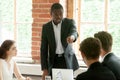 Rude african businessman pointing finger at white colleague duri