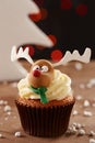 Rudolph reindeer cupcake on Christmas background