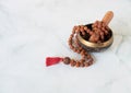 Rudra Japamala on a singing bowl on a white background. Meditation concept