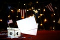 Ruffled American flag and wooden cube calendar with 4th of July, USA Independence Day date, copy space celebratory background. US Royalty Free Stock Photo