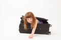 Ruffled girl comes out of the travel suitcase