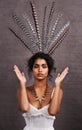 Ruffling feathers. Cropped portrait of a stylish young ethnic woman posing with feathers in a studio. Royalty Free Stock Photo