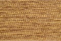 Rug is alternating pattern of brown and beige thick woolen threads running horizontally on basis of vertical threads in columns