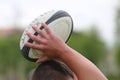 Rugby ball in hands Royalty Free Stock Photo