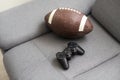 rugby ball, joystick, video game at home.