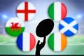 Rugby ball silhouette in hand. Flags of Six Nations, England, Wales, France, Italy, Ireland, Scotland