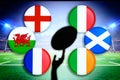 Rugby ball silhouette in hand. Flags of Six Nations, England, Wales, France, Italy, Ireland, Scotland