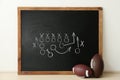 Rugby balls near chalkboard with football game scheme