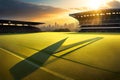 A rugby field bathed in golden sunlight during a match, with long shadows cast by the players