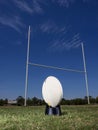 Rugby football positioned in front of the goal posts. Royalty Free Stock Photo