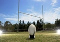 Rugby football positioned in front of the goal posts. Royalty Free Stock Photo