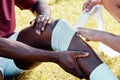 Rugby, knee injury and bandage with a sports black man on a field struggling with pain during a game. Fitness, medical Royalty Free Stock Photo