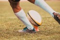 rugby player preparing to kick the oval ball during game Royalty Free Stock Photo