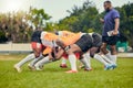 Rugby, scrum or men training with coach on grass field ready for match, practice or sports game. Fitness, performance or