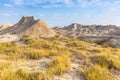 Grasslands give way to eroded hills in Badlands National Park. Royalty Free Stock Photo