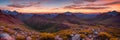 Rugged beauty of a mountain range at golden hour, with the sun setting in the background Royalty Free Stock Photo