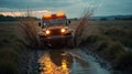 rugged car splashes through a muddy trail at sunset Royalty Free Stock Photo