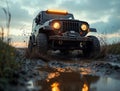 rugged car splashes through a muddy trail at sunset Royalty Free Stock Photo
