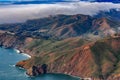 Rugged cliffs above Pacific Ocean by Point Bonita Lighthouse and fog rolling in Marin County California fly from San Francisco USA Royalty Free Stock Photo