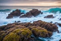 The rugged coastline is a battleground where crashing waves clash against ancient rocks, their tumultuous dance creating Royalty Free Stock Photo