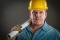 Rugged Handsome Contractor in Hard Hat Holding Floor Plans