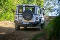 The rugged Ineos Grenadier off-road vehicle in the forest and on a dirt road