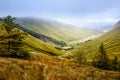 Rugged landscape at Glengesh Pass, County Donegal, Ireland. Beach with cliffs, green rocky land with sheep on foggy