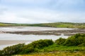 Rugged landscape at Malin Head, County Donegal, Ireland. Beach with cliffs, green rocky land with sheep on foggy cloudy Royalty Free Stock Photo