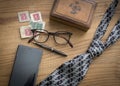 Blsck and silver necktie and glasses with phone make a father`s day vignette