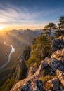 Rugged mountain landscape at sunset with a winding river below, casting a reflective Royalty Free Stock Photo