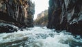 Turbulent river flowing through narrow rocky canyon with steep cliffs and sparse vegetation Royalty Free Stock Photo