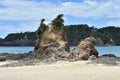 Rugged rock formation on sandy beach
