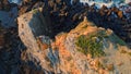 Rugged rock formation sunny day closeup. Aerial volcanic beach washing by ocean Royalty Free Stock Photo