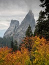 Rugged rock pillars above autumn foliage