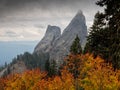 Rugged rock pillars above autumn foliage