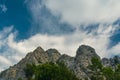 Rugged rocky mountain peaks rising sharply beneath dynamic clouds Royalty Free Stock Photo