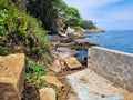 A rugged stone walkway hugs the shoreline Playa La Angosta, Acapulco Royalty Free Stock Photo