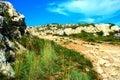 Rugged trail rising through the rocks of a canyon near the city of Matera