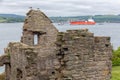 Ruin Incholm Abbey at Inchcolm Island with freighter and tugboats Royalty Free Stock Photo