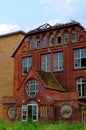 Ruin of a large brick house after a fire in the attic to clarify fire damage Arson theft and vandalism Royalty Free Stock Photo