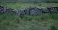 Ruin of old stone wall in rural Portugal. Straight view. Royalty Free Stock Photo