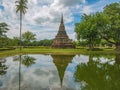 Ruin of Pagoda in Wat mahathat Temple Area and reflection in the water At sukhothai historical park Royalty Free Stock Photo