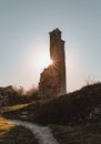 Ruin tower of Ghymes Castle in Slovakia Europe with sunrays on sunset. Vertical photo of ruin with path Royalty Free Stock Photo