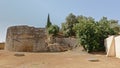 Ruin of a tower surrounded by trees in Italica, Roman city in the province of Hispania Baetica