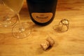 Ruinart Champagne Bottle, Cork and Champagne Glasses on a Table