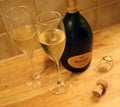 Ruinart Champagne Bottle, Cork and Champagne Glasses on a Table