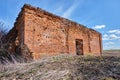 A ruined ancient Christian church made of red brick in summer in the daytime against a blue sky. Royalty Free Stock Photo