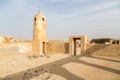 Minaret in ruined ancient old Arab pearling and fishing town Al Jumail, Qatar. The desert, coast of Persian Gulf. Pile of stones.